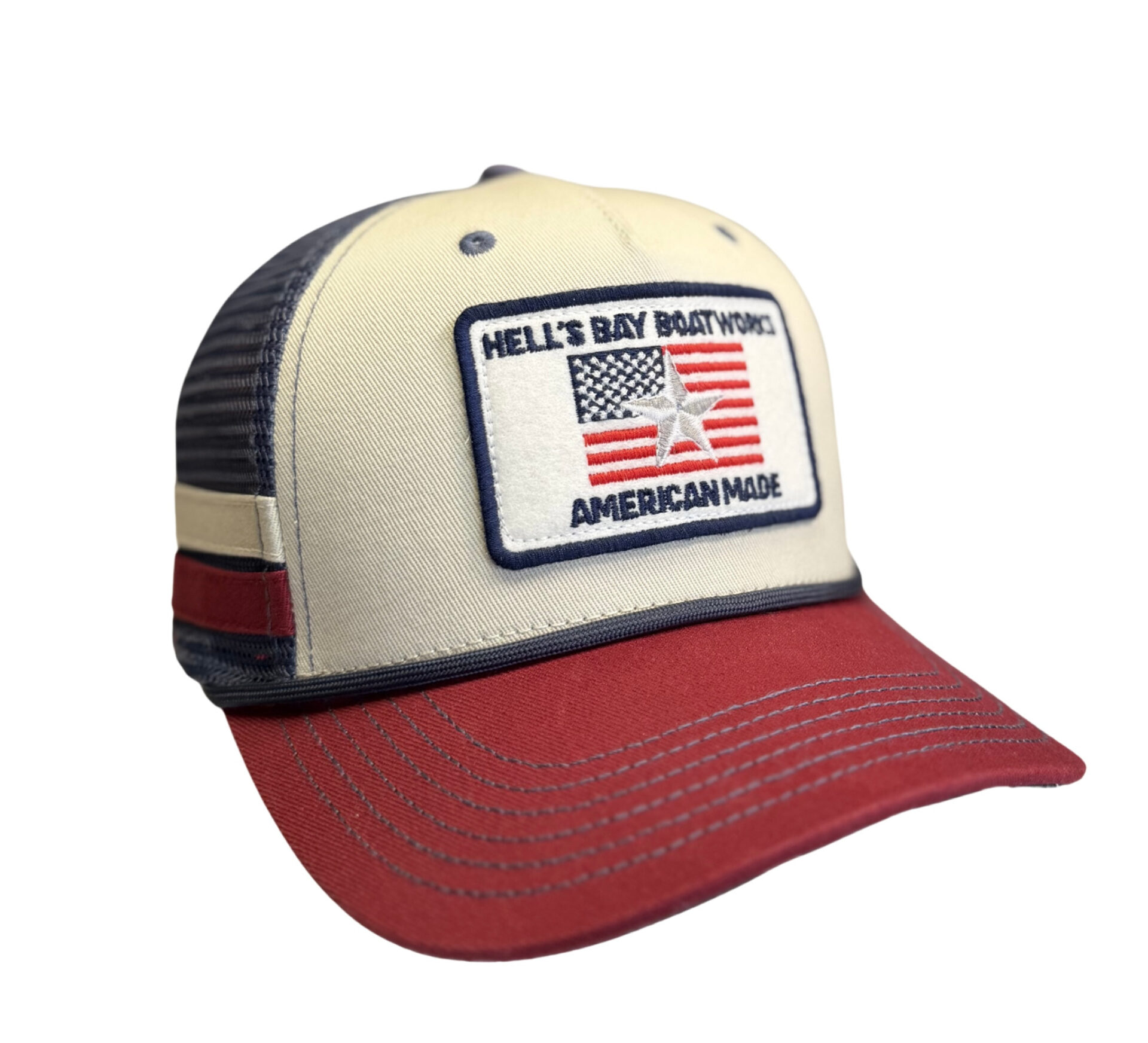 Cap with American flag patch and Hell's Bay Boat Works' branding on a white background