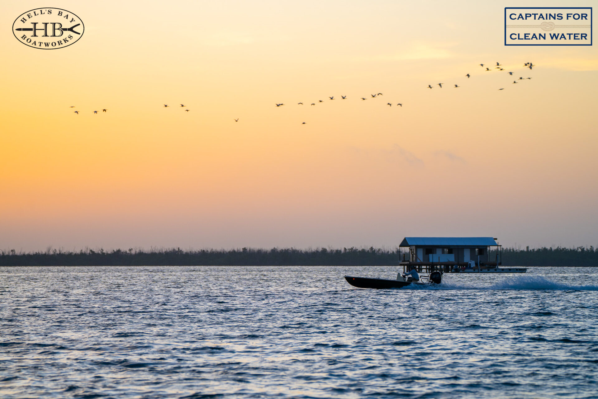 Hell's Bay skiff running at sunset