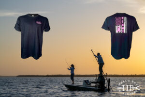 Hell's Bay Cancer awareness tee shirt with a fishing backdrop